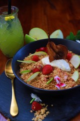 Crunchy Granola with dehydrated organic pear, sliced green apple, strawberries and vanilla bean yoghurt