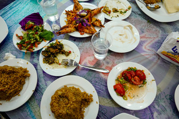 Marsa Matruh, Egypt  An assortment of dishes at a local fish restaurant including grilled shrimp, rice, eggplant, salads.