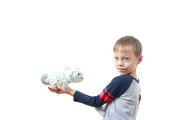 Infatuated child boy playing plastic toy lizard robot with a remote control, isolated on white...