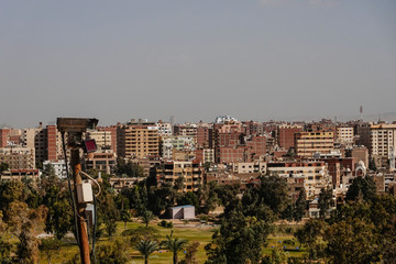 Cairo, Egypt The skyline of Cairo and Giza seen from the grounds of the Pyramids of Giza, and a...
