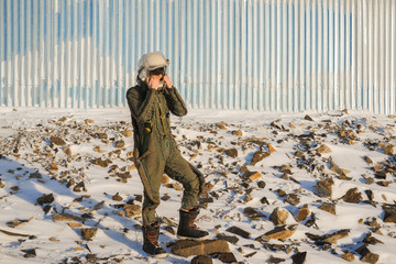 Naklejka premium Pilot astronaut is on a snow-capped top. Astronaut in a protective suit and helmet.