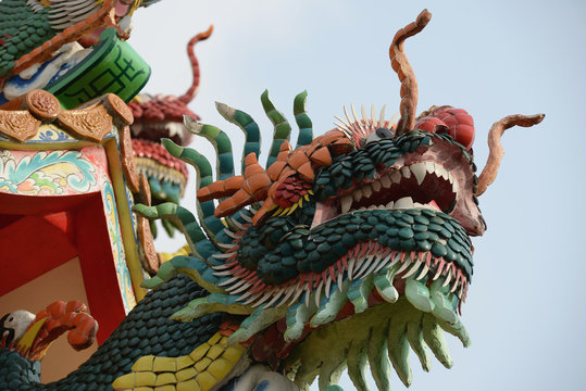 chinese dragon statue on the roof of temple