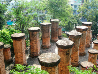Fototapeta premium Old stone columns from the temple of Vietnam on a summer sunny day