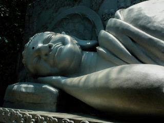 White Stone sleep Buddha Statue in Vietnam on a Summer Sunny Day