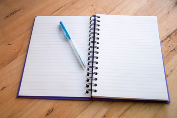 Pen and Notepad on the wooden desk