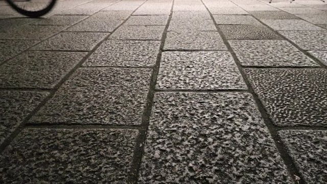 low angle shot side walk, street concept, bicycle riding by after work hour, grey pattern stone tile round, architecture, light shadow, thoughtful, opportunity success road, city life, urban