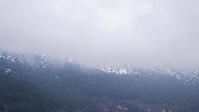 4K. View of winter mountain Troodos in Cyprus. Tilt up from foot of the mountain to cloud.