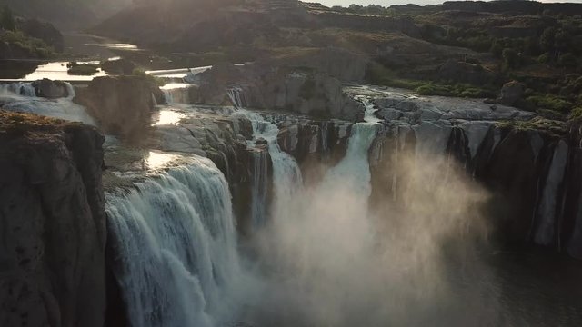 Spectacular Shoshone Falls Drone Aerial View. Snake River Waterfall Under Sunset Sunlight and Water Mist