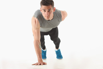 Fototapeta premium Fitness man wringing from the floor demonstrates good physical exercises isolated on white background healthy lifestyle for many people exercising their own weight for losing for every day push up.