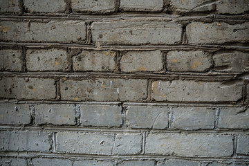 Texture of an old paint covered brick wall. Background image of an abandoned brick wall with painted over paint