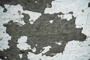 Texture of an old cracked concrete wall. Background image of a worn gray concrete surface