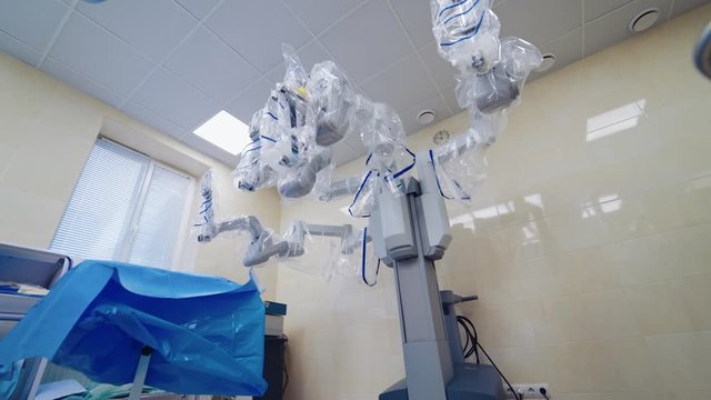 Medical surgical robot in the operating room. Modern medical equipment in clinic. Minimally invasive robotic surgery.