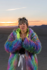 Young asian female dressed in rainbow furry coat for festival