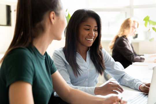 Attractive biracial and european coworkers working on common project