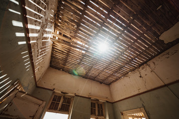 Damaged Building Roof with sunlight shinigh through