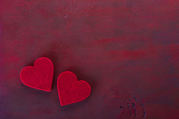  Two hearts on the wooden board painted in dark-red with copy space for text. Flat lay.  Valentine's day background.