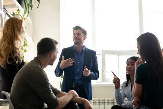 Office members chatting during break gathered together in coworking space