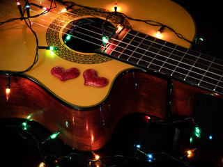 red glitter hearts and glowing string lights  on acoustic guitar , Valentine's day concept
