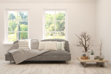 Stylish room in white color with sofa and summer landscape in window. Scandinavian interior design. 3D illustration