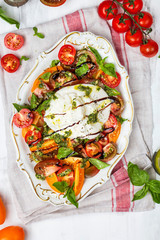 Buffalo burrata cheese with fresh raw tomatoes and basil
