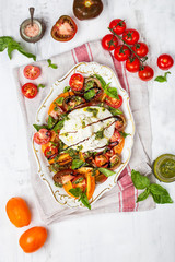 Buffalo burrata cheese with fresh raw tomatoes and basil