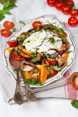 Buffalo burrata cheese with fresh raw tomatoes and basil