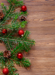 Christmas background with xmas tree and red berries on  wooden background. Merry christmas greeting card, frame, banner. Winter holiday theme. Happy New Year. Space for text.