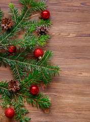 Christmas background with xmas tree and red berries on  wooden background. Merry christmas greeting card, frame, banner. Winter holiday theme. Happy New Year. Space for text.