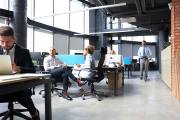 Group of happy progressive business people working on startup together at creative office