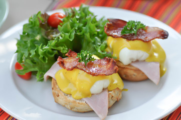 egg benedict or bun with egg and ham topping