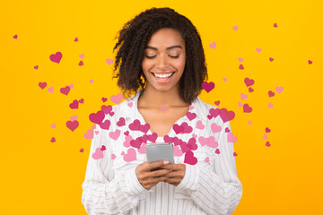 Happy black woman using online dating service