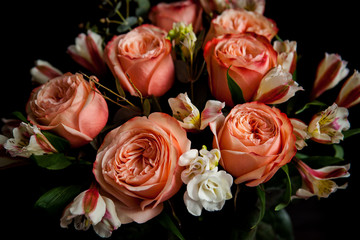 dark luxurious bouquet of gorgeous pink roses for Valentine's day on a dark wood background