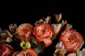 dark luxurious bouquet of gorgeous pink roses for Valentine's day on a dark wood background