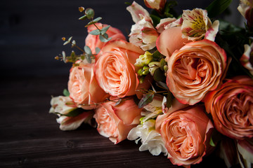 dark luxurious bouquet of gorgeous pink roses for Valentine's day on a dark wood background