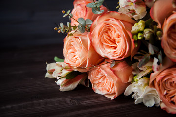 dark luxurious bouquet of gorgeous pink roses for Valentine's day on a dark wood background