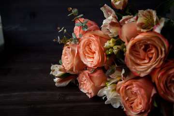 dark luxurious bouquet of gorgeous pink roses for Valentine's day on a dark wood background