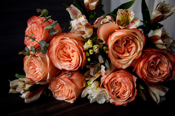 dark luxurious bouquet of gorgeous pink roses for Valentine's day on a dark wood background