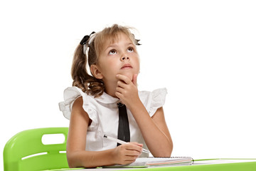 Naklejka premium Portrait of cute smart minded schoolkid doing hometask