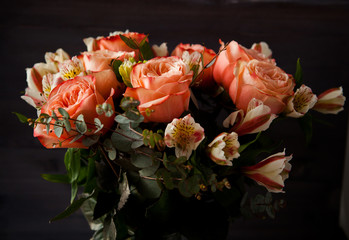 dark luxurious bouquet of gorgeous pink roses for Valentine's day on a dark wood background