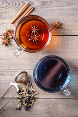 Various kinds of tea, collection of cinnamon anise spiced and blue anchan tea drinks in glass mugs