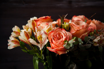 dark luxurious bouquet of gorgeous pink roses for Valentine's day on a dark wood background