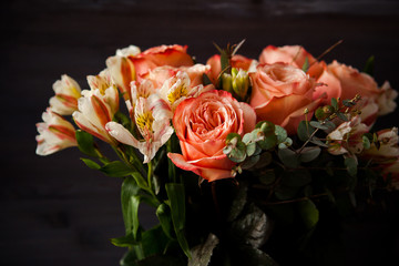 dark luxurious bouquet of gorgeous pink roses for Valentine's day on a dark wood background
