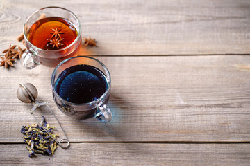 Various kinds of tea, collection of cinnamon anise spiced and blue anchan tea drinks in glass mugs