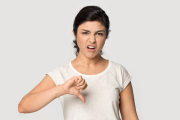 Dissatisfied young indian ethnicity female client giving negative feedback.