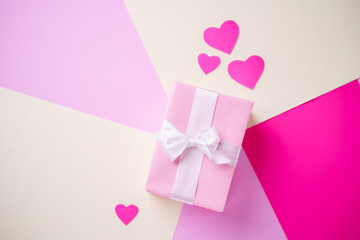 Valentine's, Mother's or Women's Day celebration. creative layout made of festive heart shaped decorations with gift box. holidays background concept