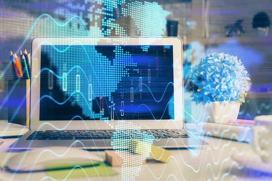 Financial graph colorful drawing and table with computer on background. Double exposure. Concept of international markets.