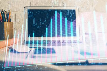 Stock market graph and table with computer background. Multi exposure. Concept of financial analysis.