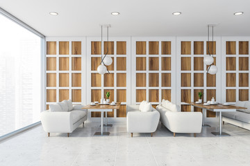 White and wooden restaurant interior with sofas