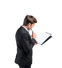 Thoughtful businessman with clipboard, side view