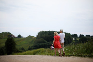 Pregnant girl with big belly and young man outdoor